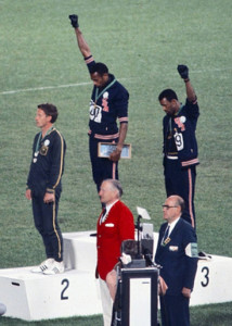 The american sprinters Tommie Smith,John Carlos and Peter Norman during the award ceremony of the 200 m race at the Mexican Olympic games. During the awards ceremony, Smith and Carlos protested against racial discrimination: they went barefoot on the podium and listened to their anthem bowing their heads and raising a fist with a black glove. Mexico City, Mexico, 1968 Mexico city, Mexico, 1968